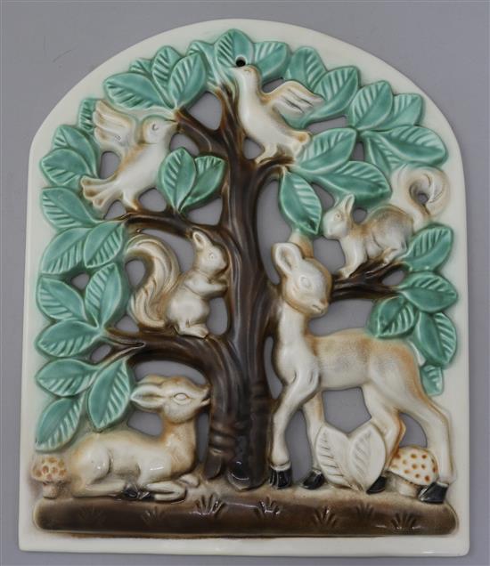 A Poole Pottery Picotee pierced wall plaque designed by Lily ,Markus, slip-cast with a tree with deer, squirrels and birds.